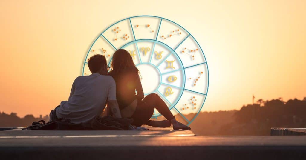 couple on date at sunset with zodiac wheel