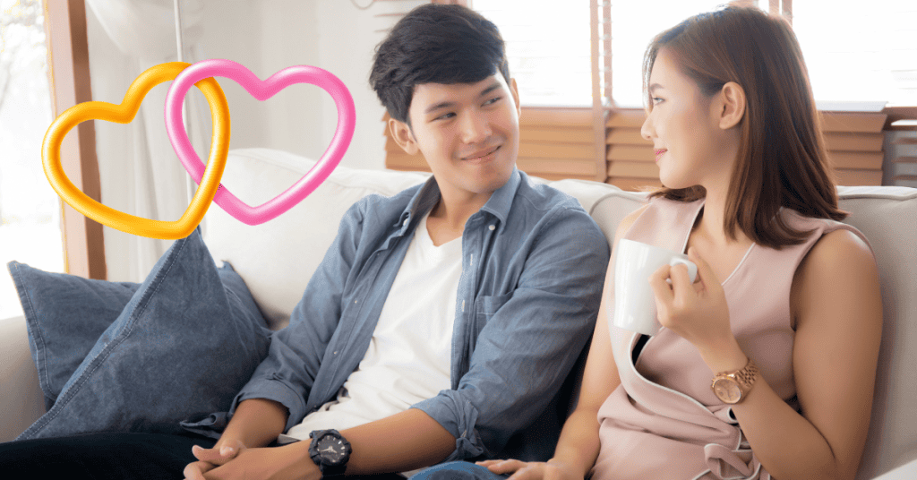 couple talking on couch together with connected hearts