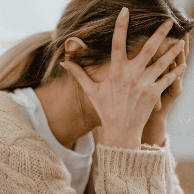 Woman Covering Her Face with Her Hands